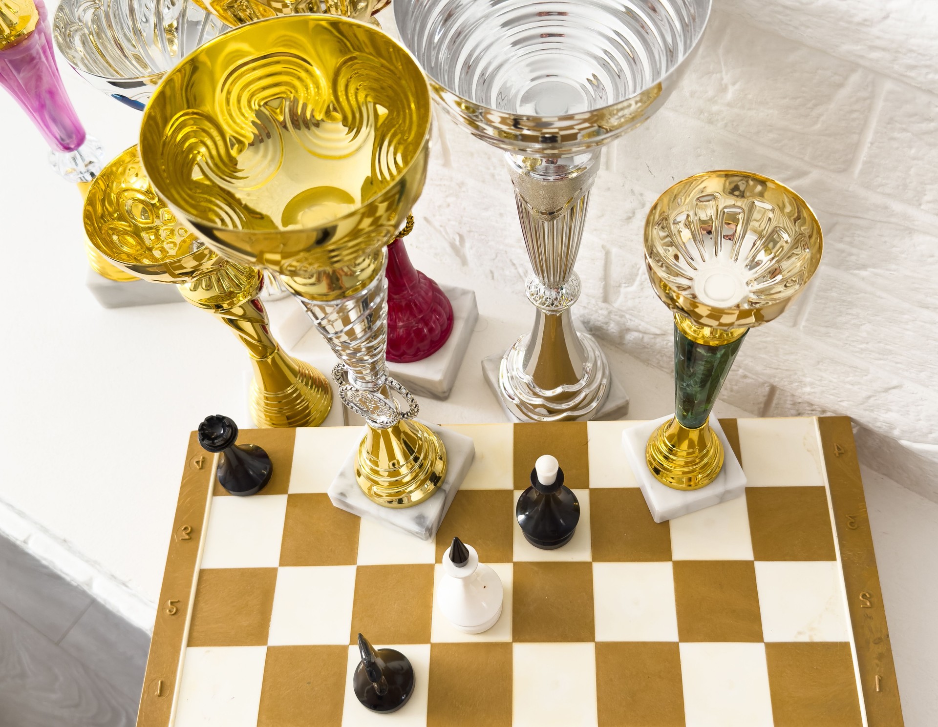 trophies for the winners and chess pieces on the chessboard